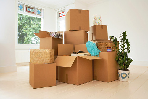 Stack of cardboard boxes in an empty apartment