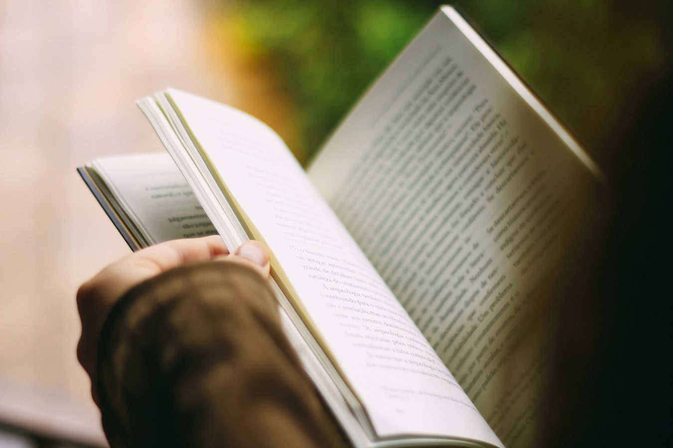 Hands holding a book open